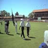 The umpires walk out onto the ground at the start of the day