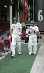 Daniel Vettori and Daniel Flynn walk out to bat