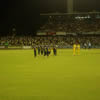 Shane Warne leads his side off the ground at a packed WACA